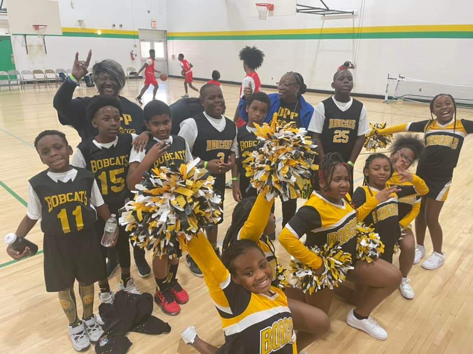 Opp Bobcats Basketball and Cheer teams on basketball court