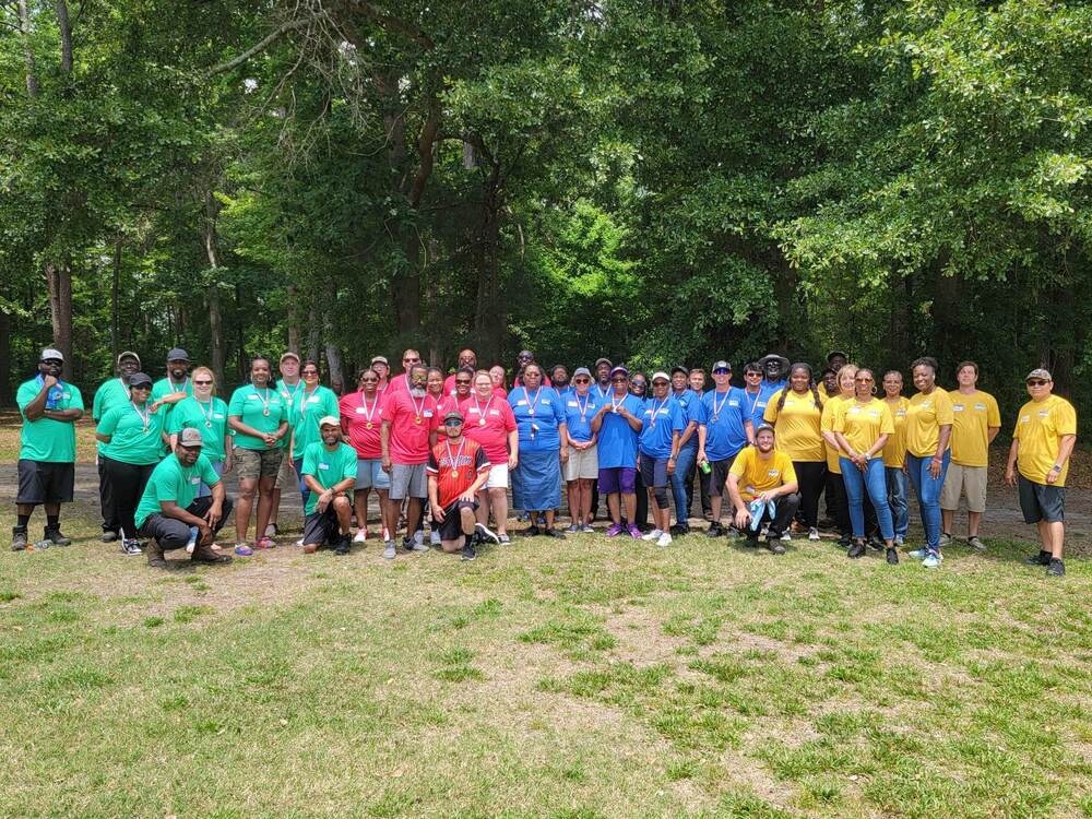 Goldsboro Housing Authority Employees outside in colorful shirts