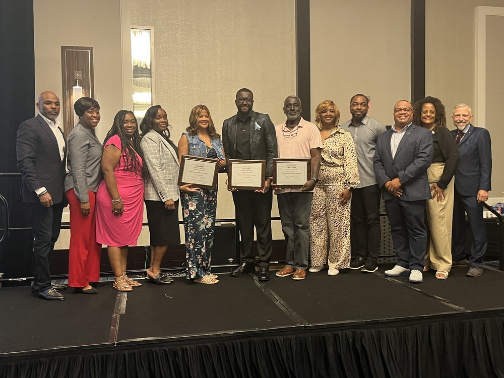 Goldsboro Resident Services team on stage receiving national award