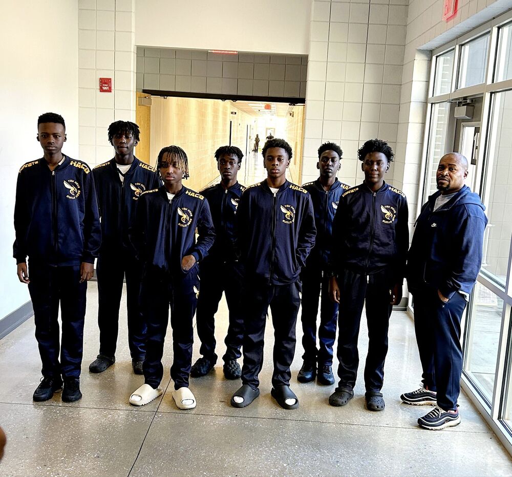 hacg hornet boys basketball team standing in hallway.jpg