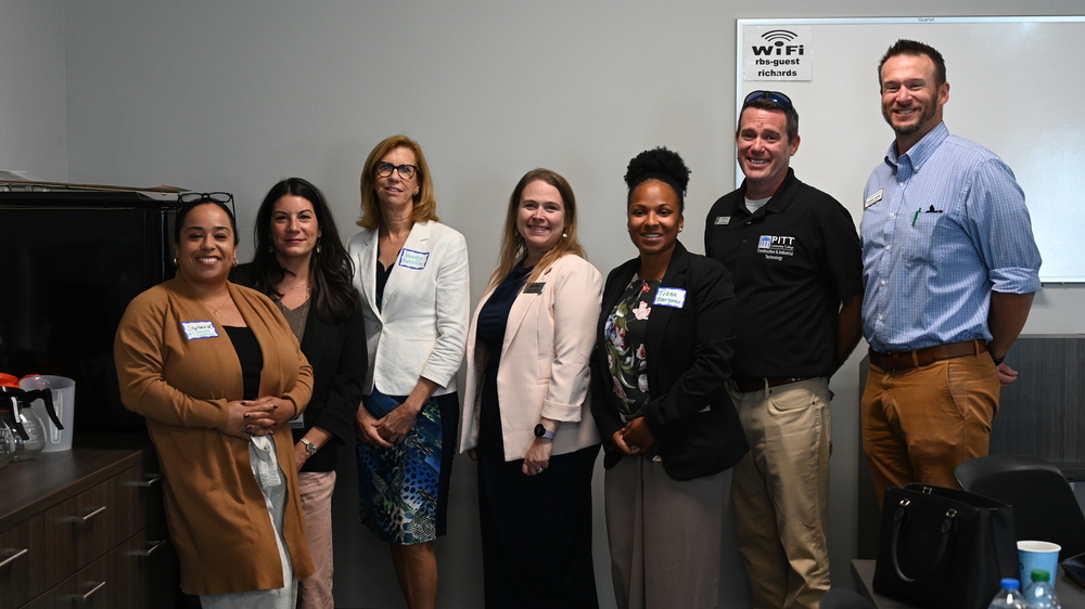 Public and Private Partnership Group posing in front of whiteboard at recent affordable housing discussion