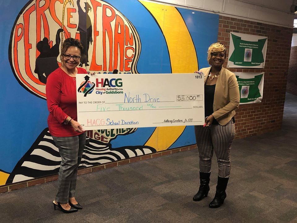 HACG with North Drive Principal presenting monetary donation 