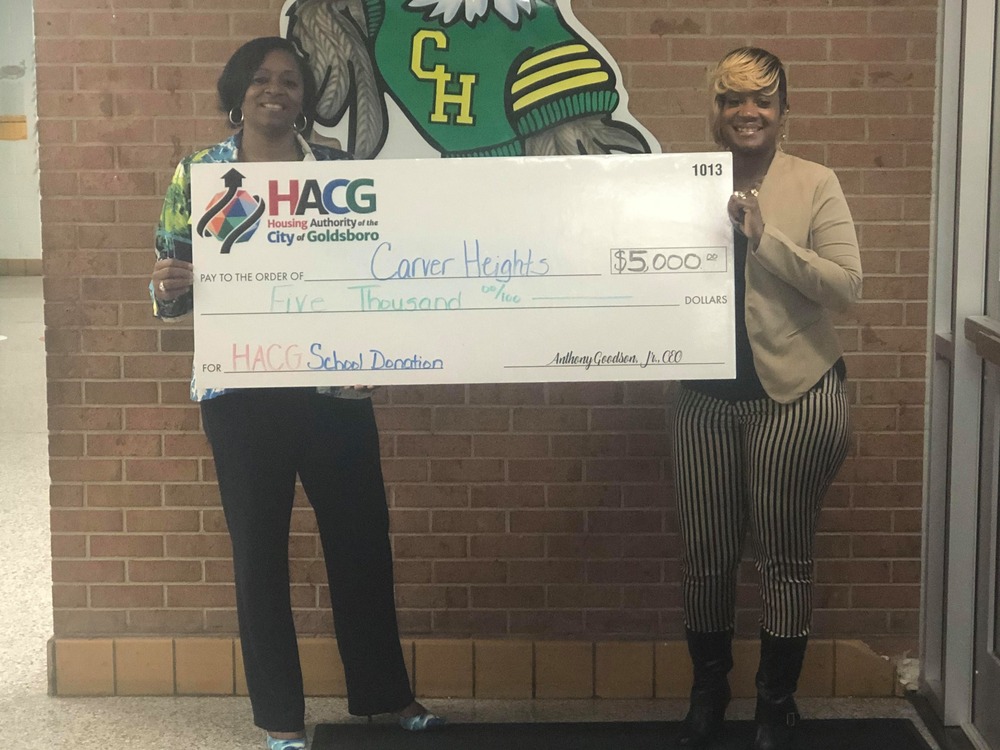 HACG staff with Carver Heights Staff presenting check