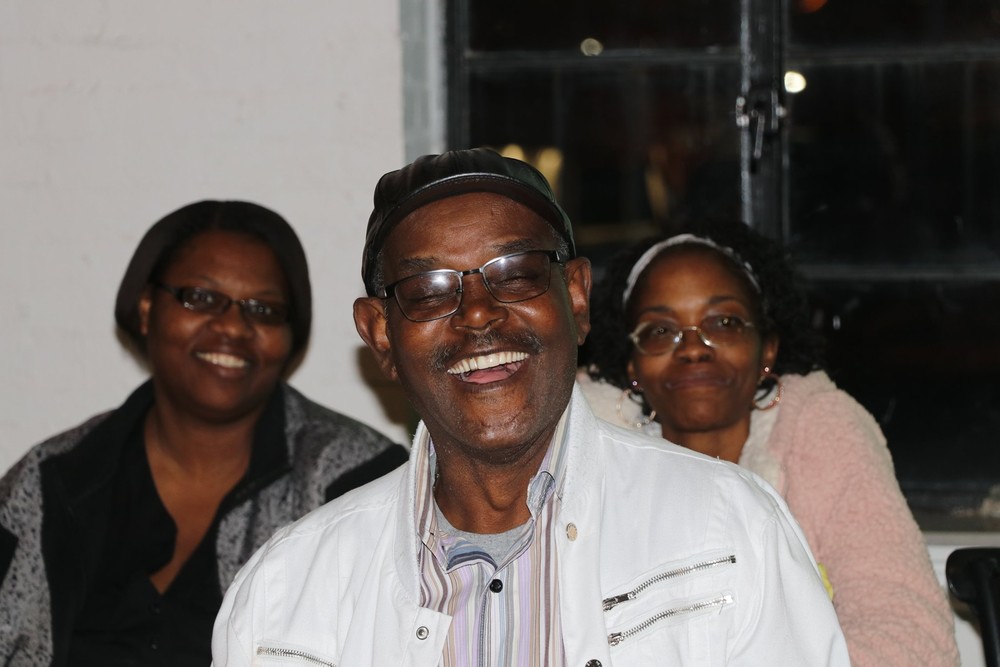 male with 2 females smiling at banquet 