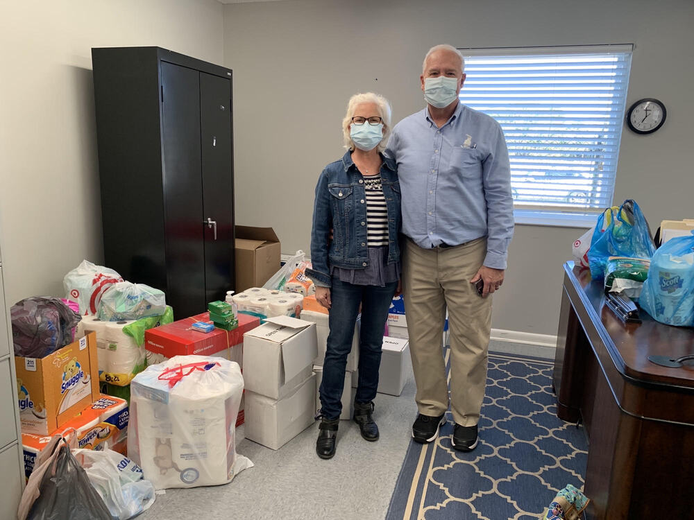 first baptist church goldsboro pastors standing in office with bags of supplies