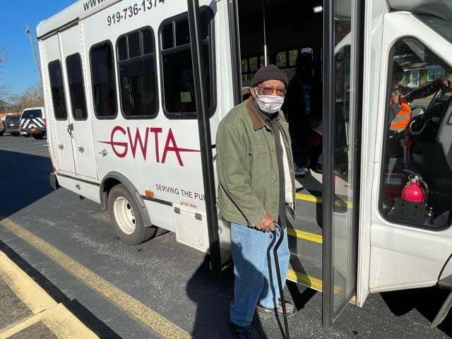 Senior Resident getting on bus to get vaccine