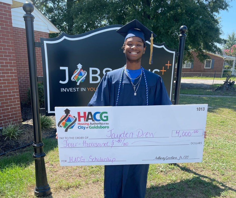 Jayden Drew holding HACG scholarship check for $4000
