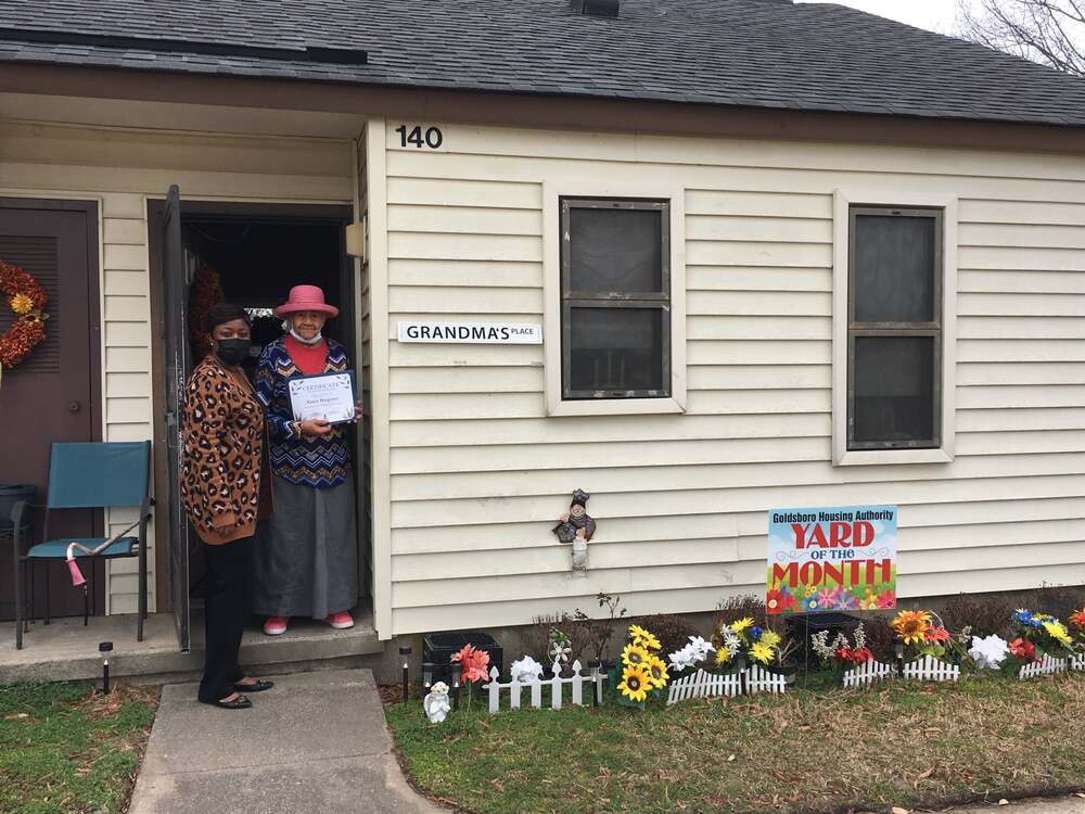 Annie Hargrove yard of the month winner holding certificate