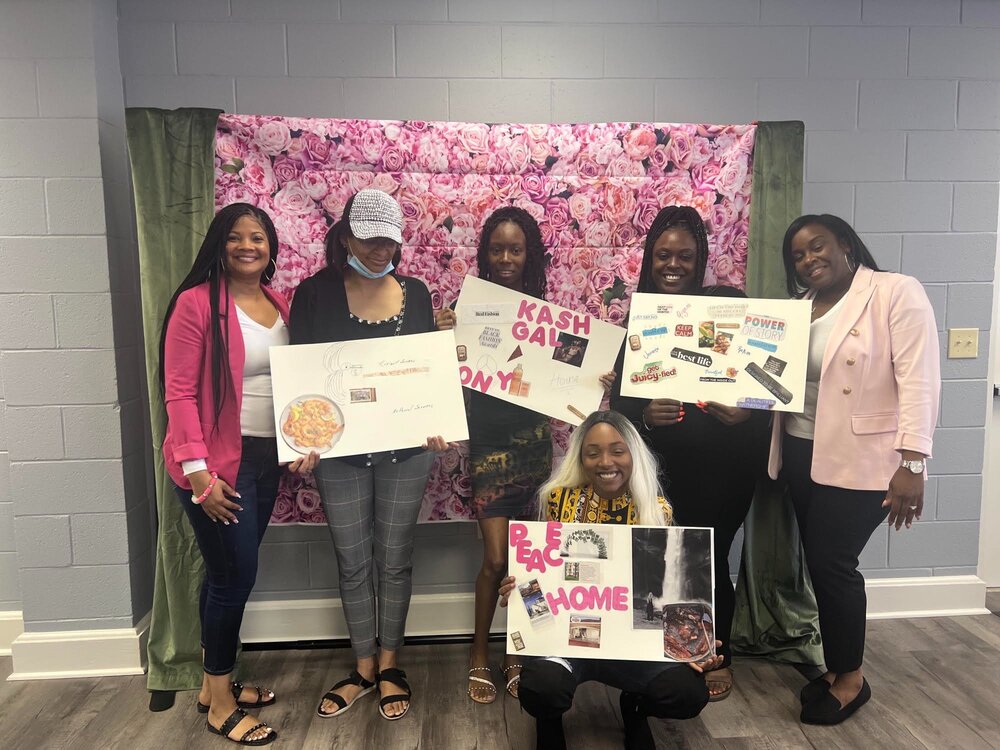 Muffins for Mom celebration group holding their vision boards